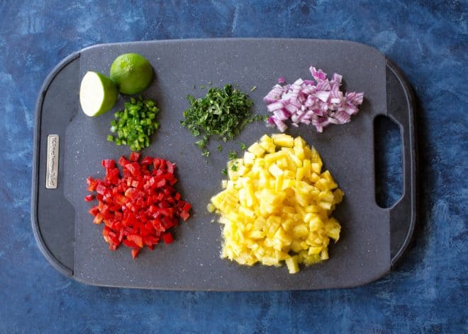 Ingredients for pineapple salsa on a cutting board