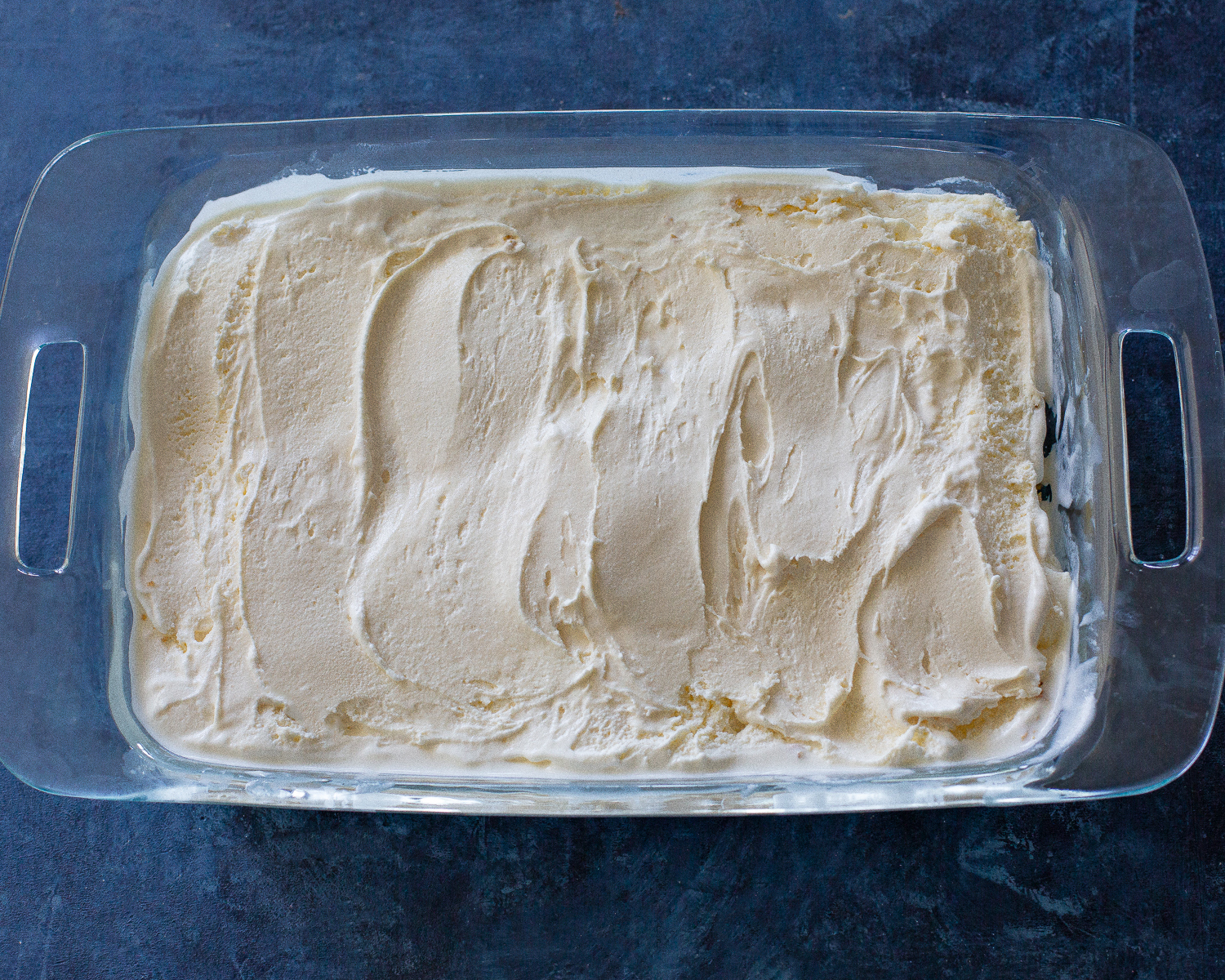 This Crunchy Ice Cream Dessert layers has of coconut, crushed cornflakes, brown sugar, and melted butter. #crispy #ice #cream #dessert