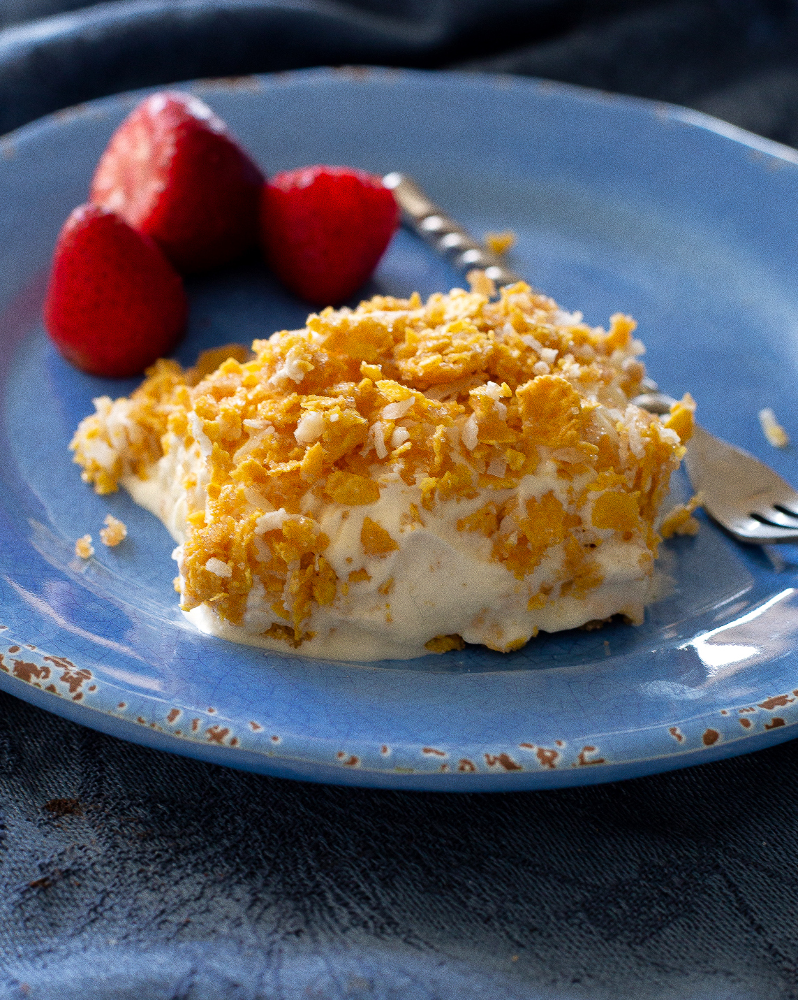 This Crunchy Ice Cream Dessert layers has of coconut, crushed cornflakes, brown sugar, and melted butter. #crispy #ice #cream #dessert