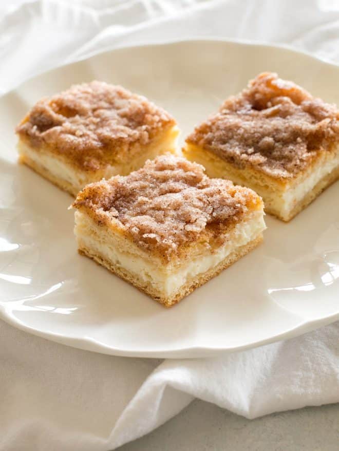 slices of sopapilla cheesecake on a white plate