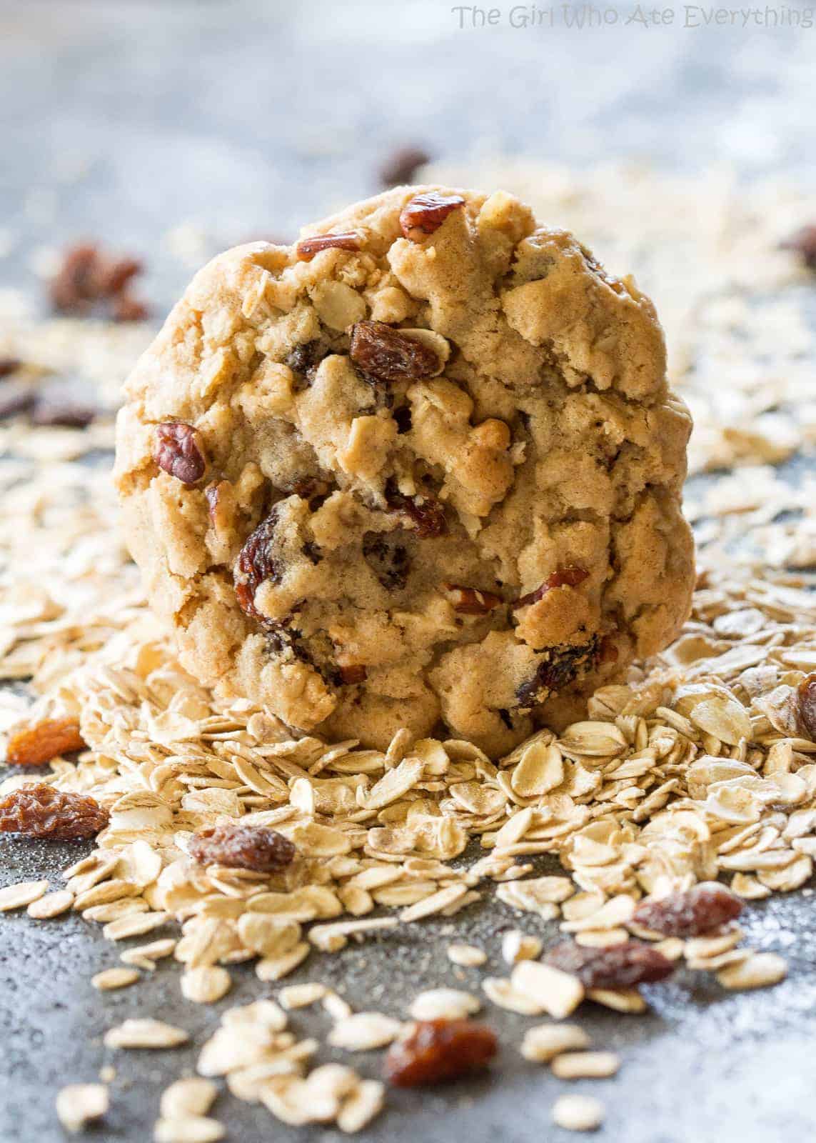 Chewy Oatmeal Raisin Cookie in a pile of oats and raisins
