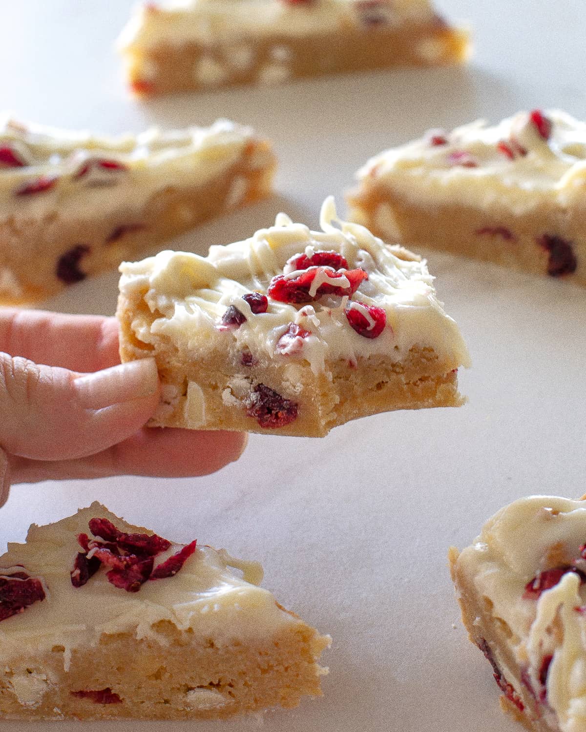 Cranberry Bliss Bars slice with a bite