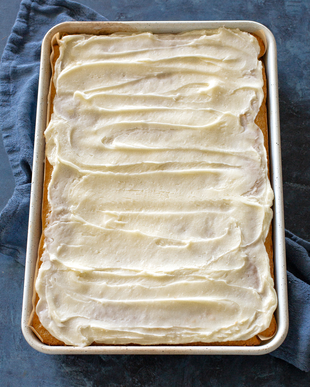 White Texas Sheet Cake is a great cake for feeding a crowd. Buttery, moist, and covered in an almond flavored frosting, this cake is a tried and true recipe. #white #texas #sheet #cake #recipe