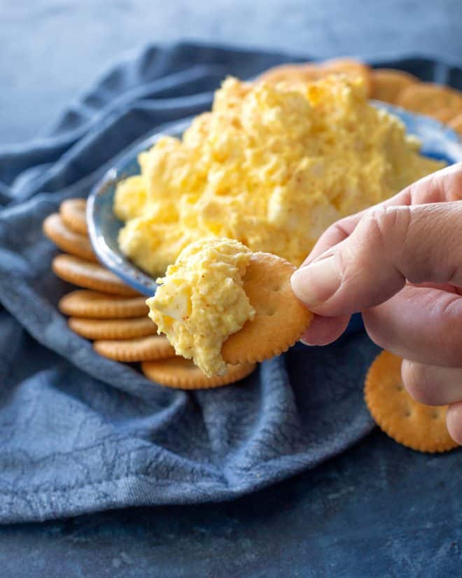 deviled egg spread on a cracker