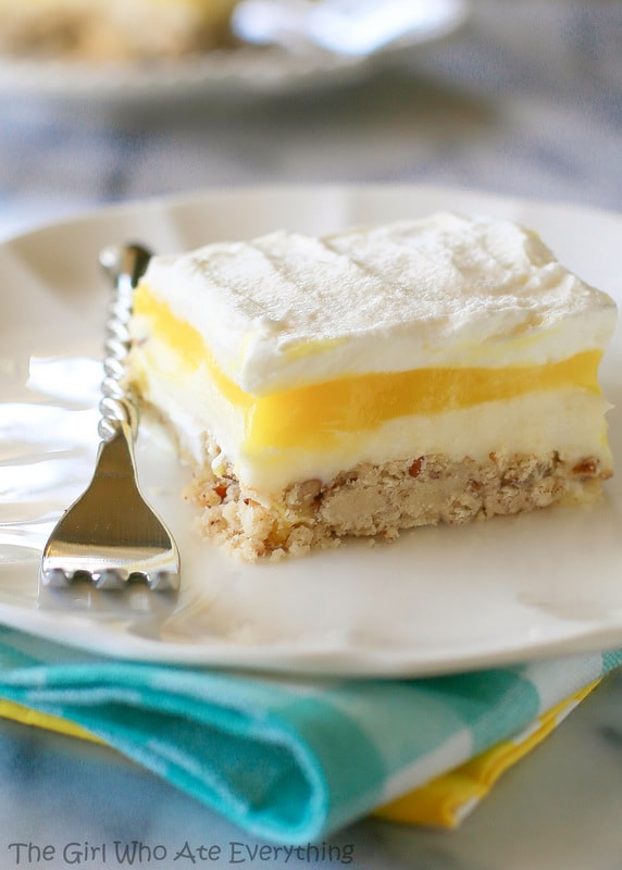 Lemon Lush slice on a plate with a fork