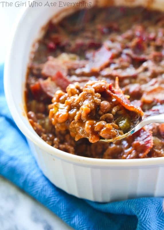 a spoon of baked beans in a white dish