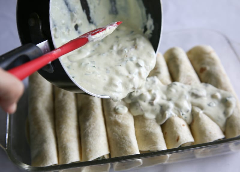 Chicken, Spinach, and Mushroom Enchiladas - creamy enchiladas topped with a cilantro sour cream sauce. This dish is company worthy. the-girl-who-ate-everything.com