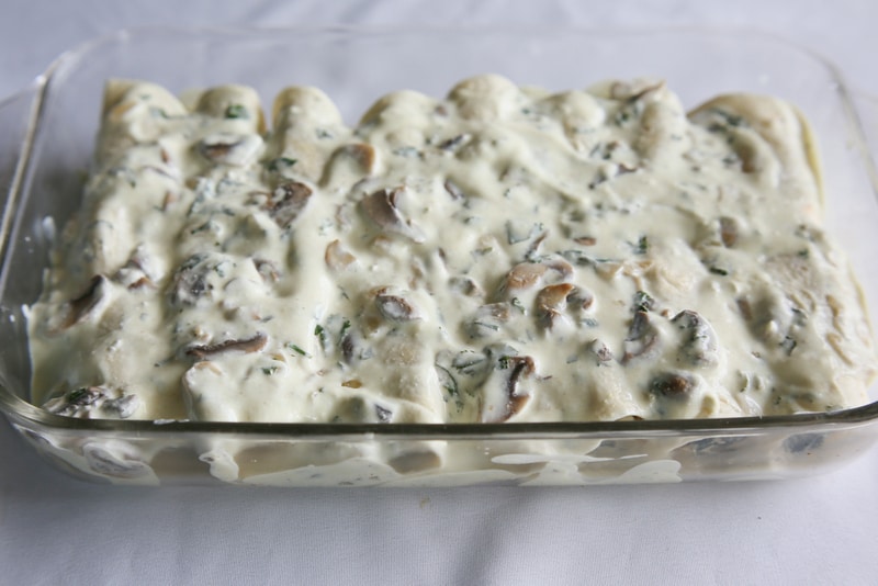 Chicken, Spinach, and Mushroom Enchiladas - creamy enchiladas topped with a cilantro sour cream sauce. This dish is company worthy. the-girl-who-ate-everything.com