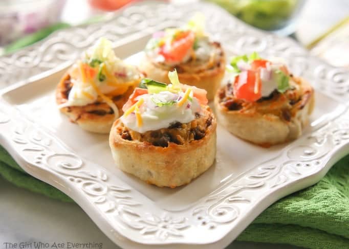 Taco Pizza Rolls - taco meat and cheese rolled up in pizza dough and topped with your favorite taco toppings. the-girl-who-ate-everything.com
