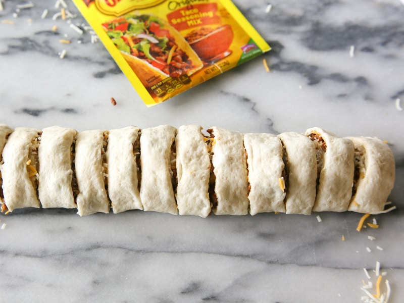 Taco Pizza Rolls - taco meat and cheese rolled up in pizza dough and topped with your favorite taco toppings. the-girl-who-ate-everything.com