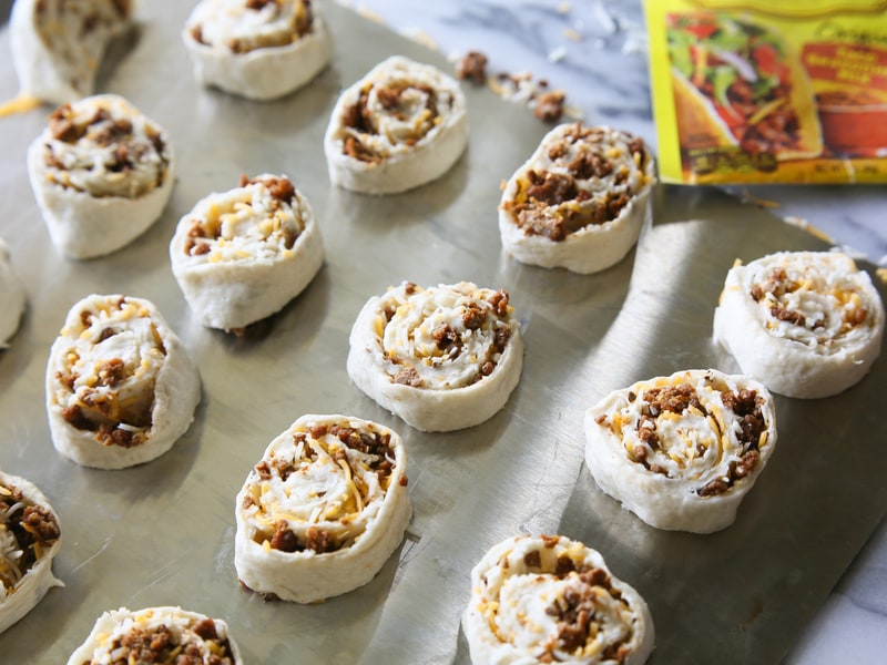 Taco Pizza Rolls - taco meat and cheese rolled up in pizza dough and topped with your favorite taco toppings. the-girl-who-ate-everything.com