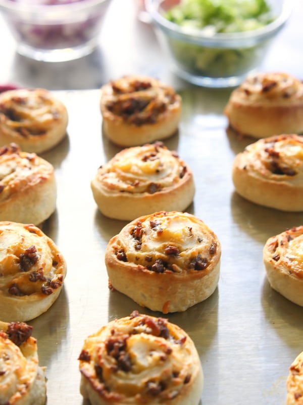 Taco Pizza Rolls - taco meat and cheese rolled up in pizza dough and topped with your favorite taco toppings. the-girl-who-ate-everything.com