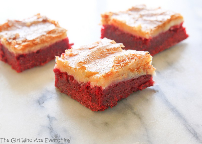 These Red Velvet Gooey Butter Bars are moist red velvet cake topped with a buttery cream cheese layer. Great for Halloween, Christmas, Valentine's Day, or the Fourth of July. the-girl-who-ate-everything.com