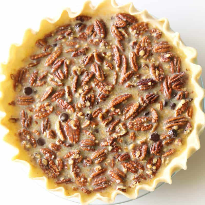 Chocolate Pecan Pie - inspired from the delicious pie from The Roaring Fork restaurant. This is a twist on the traditional pecan pie with chocolate chips and toffee bits inside. the-girl-who-ate-everything.com