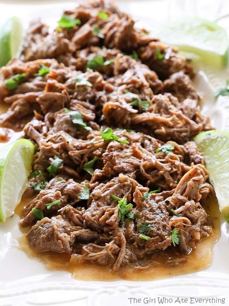 These Barbacoa Tacos are cooked in the slow cooker all day so you can come home to savory and spicy tacos. the-girl-who-ate-everything.com