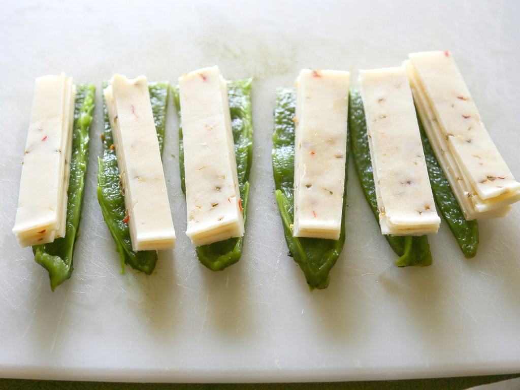 Chile Relleno Flautas - a poblano pepper and Monterey Jack cheese rolled up in a flour tortilla, sprinkled with seasoned cornmeal, and pan-fried until toasty. the-girl-who-ate-everything.com