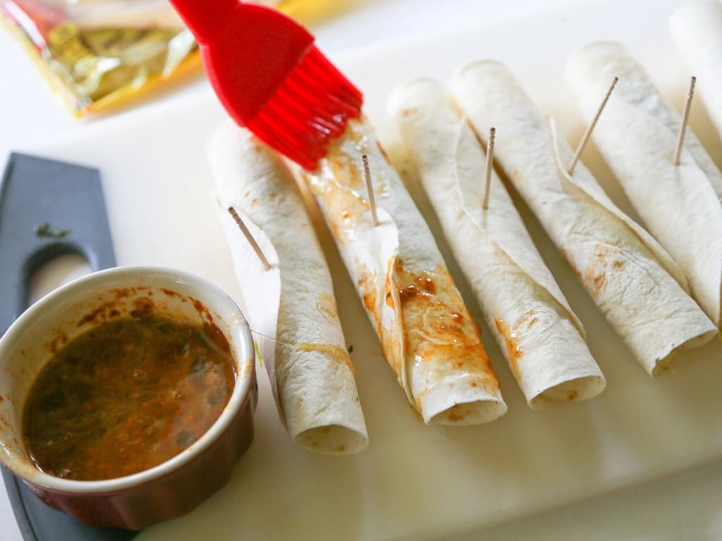Chile Relleno Flautas - a poblano pepper and Monterey Jack cheese rolled up in a flour tortilla, sprinkled with seasoned cornmeal, and pan-fried until toasty. the-girl-who-ate-everything.com