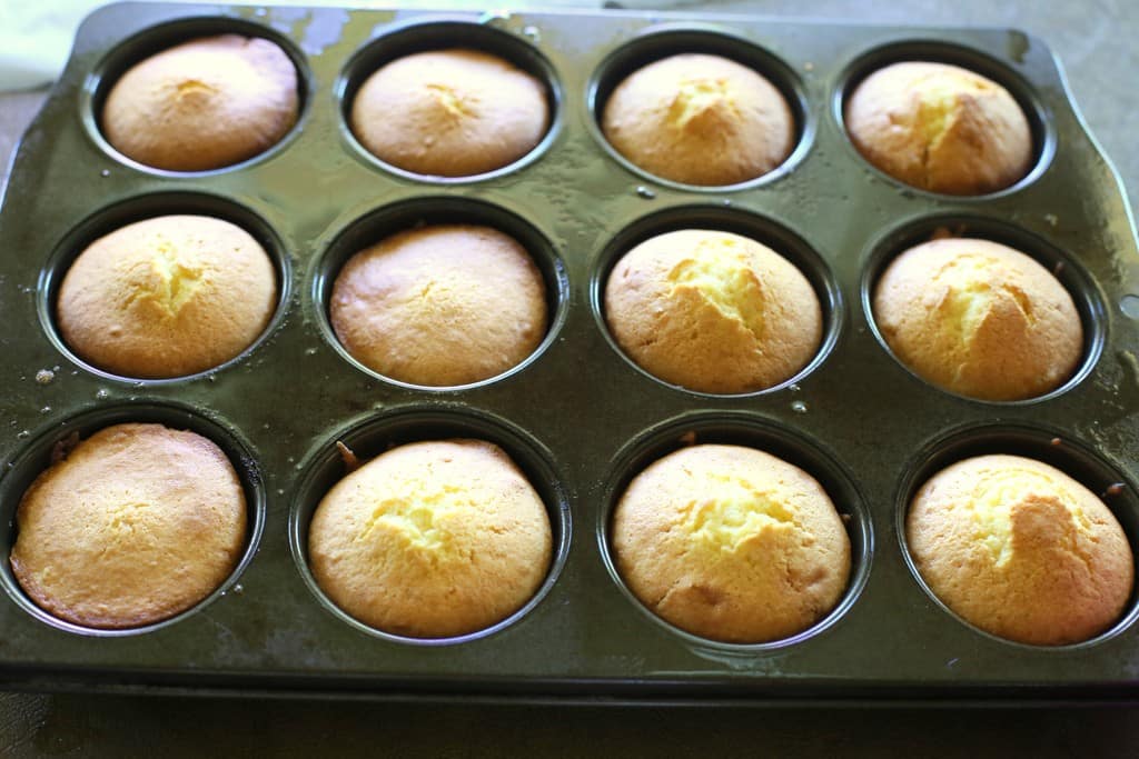 Pineapple Upside Down Cupcakes - a mini version of your favorite cake with butter, brown sugar, pineapple, and a cherry on top! the-girl-who-ate-everything.com
