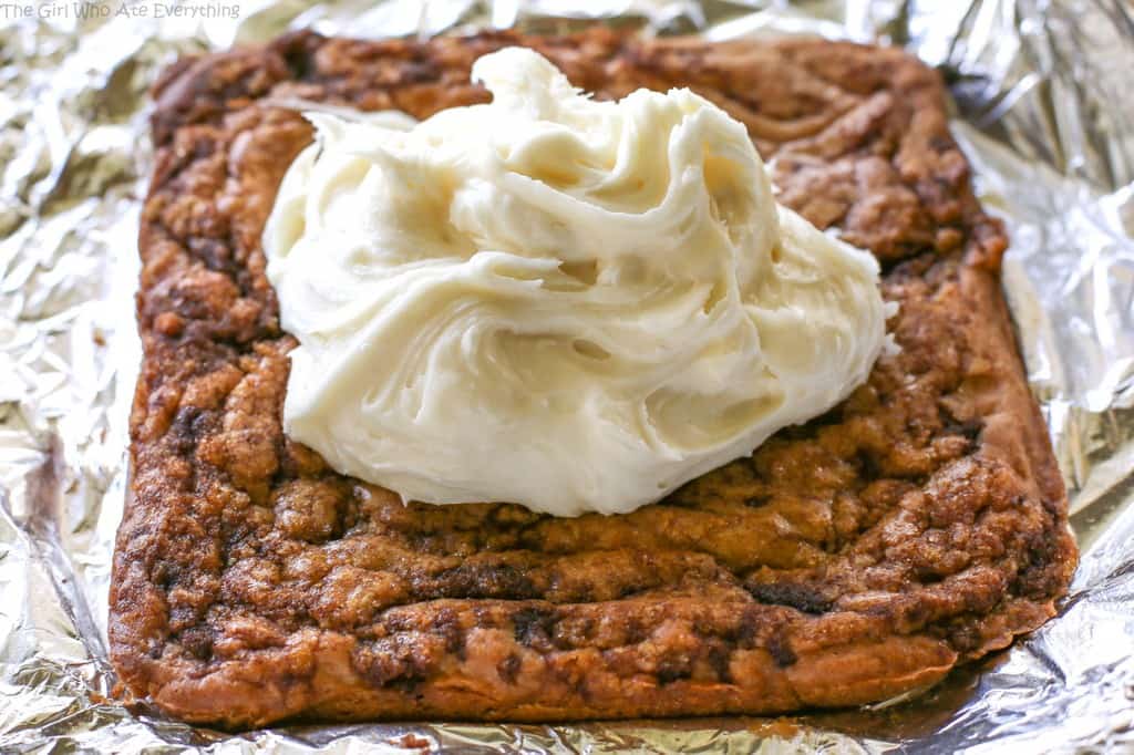Cinnamon Roll Blondies - blondies with brown sugar and cinnamon swirled in and topped with cream cheese frosting. The yummy flavors of a cinnamon roll without the trouble of yeast. the-girl-who-ate-everything.com