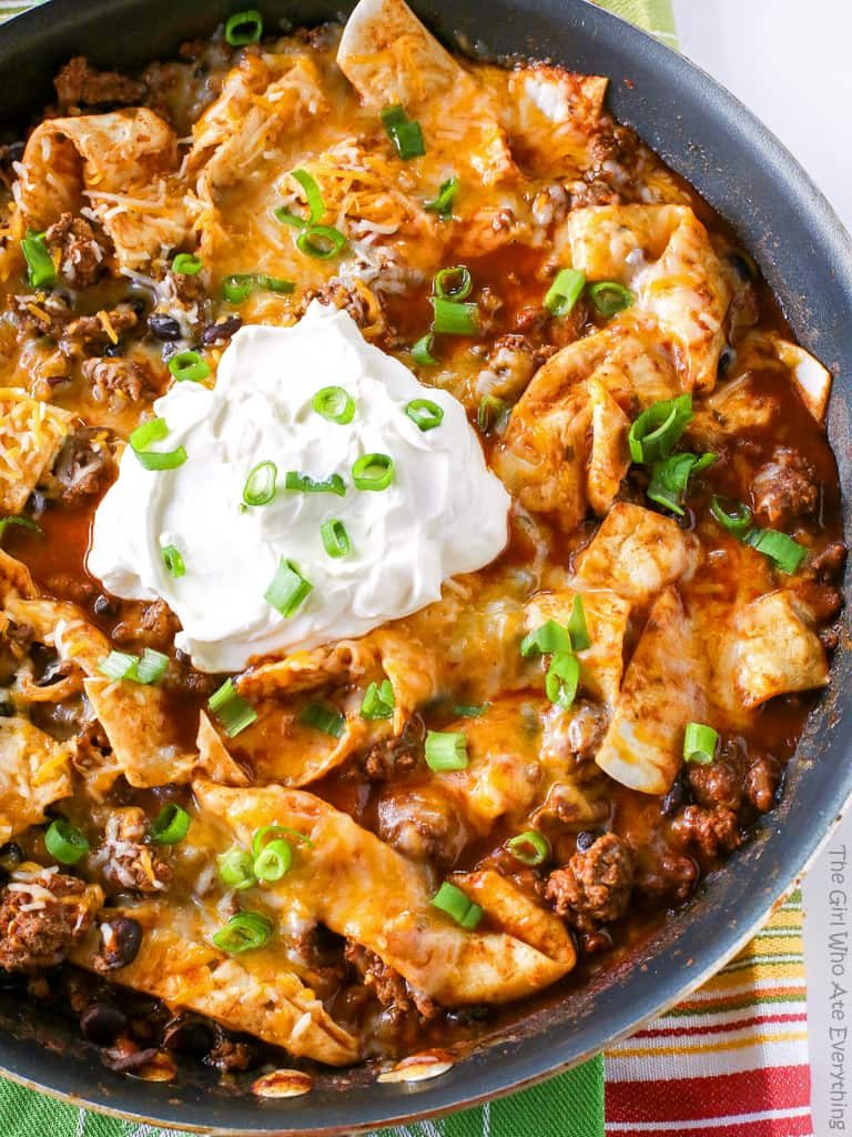 This Easy Beef Burrito Skillet has beef, black beans, salsa, and tortillas all cooked in one skillet. The tortillas turn soft and almost like a dumpling. This tasty dish is done in less than 20 minutes. the-girl-who-ate-everything.com