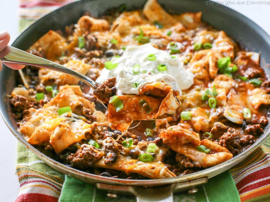 This Easy Beef Burrito Skillet has beef, black beans, salsa, and tortillas all cooked in one skillet. The tortillas turn soft and almost like a dumpling. This tasty dish is done in less than 20 minutes. the-girl-who-ate-everything.com