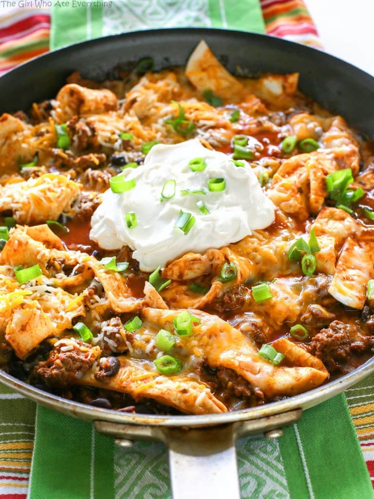 This Easy Beef Burrito Skillet has beef, black beans, salsa, and tortillas all cooked in one skillet. The tortillas turn soft and almost like a dumpling. This tasty dish is done in less than 20 minutes. the-girl-who-ate-everything.com