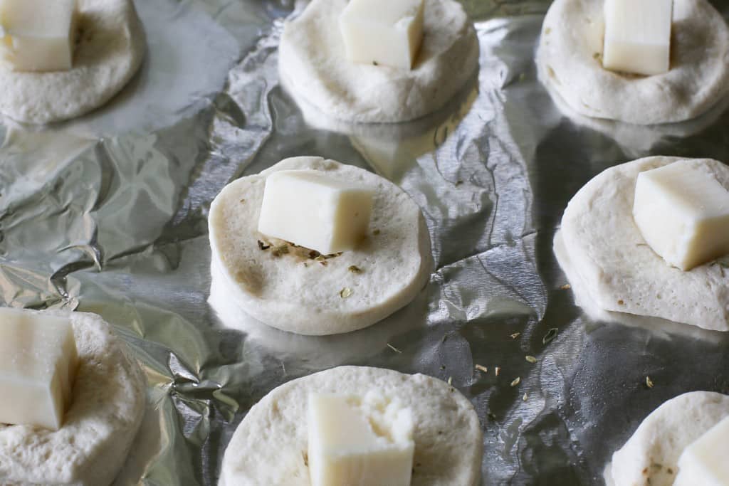 Mozzarella Puffs - dough stuffed with cubes of mozzarella cheese and brushed with pizza sauce. You could also add some pepperoni inside! These are so quick and easy. the-girl-who-ate-everything.com