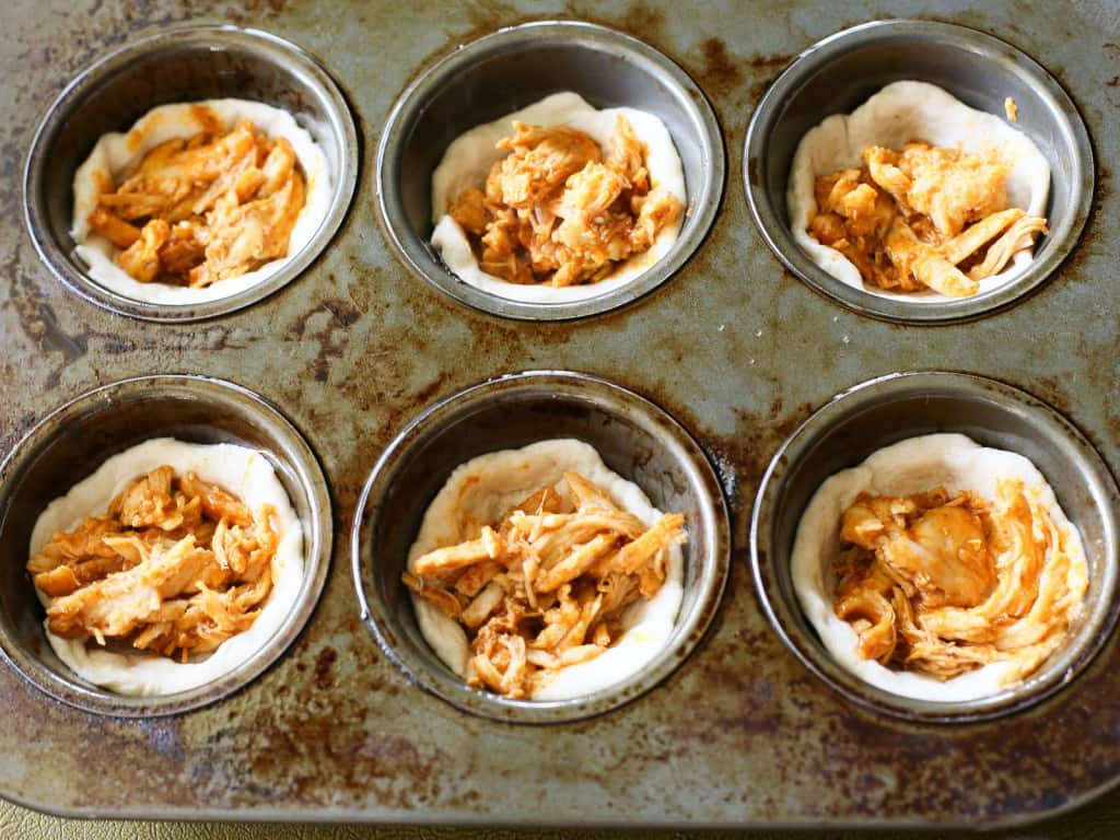 Chicken Taco Cupcakes - biscuits filled with taco chicken, cheese, and all your taco fixings. the-girl-who-ate-everything.com