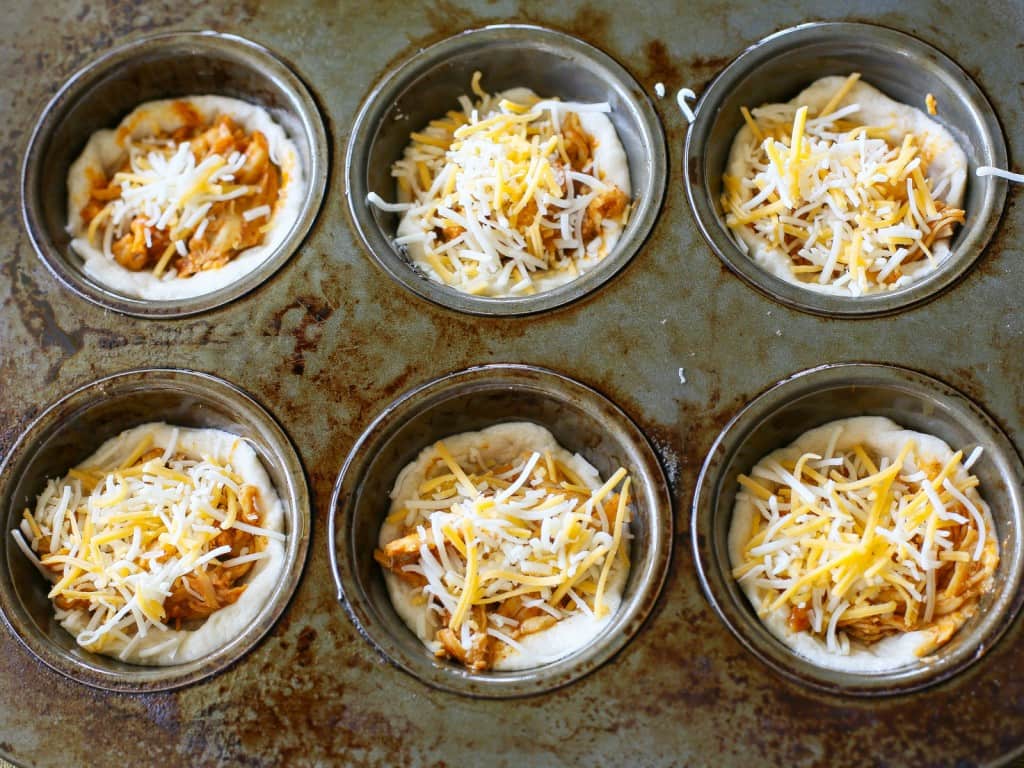 Chicken Taco Cupcakes - biscuits filled with taco chicken, cheese, and all your taco fixings. the-girl-who-ate-everything.com