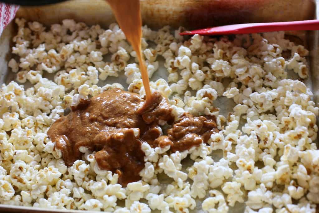 Gingerbread Caramel Popcorn - a crunchy popcorn with festive holiday flavors and drizzled with almond bark. A great neighbor gift for Christmas! the-girl-who-ate-everything.com