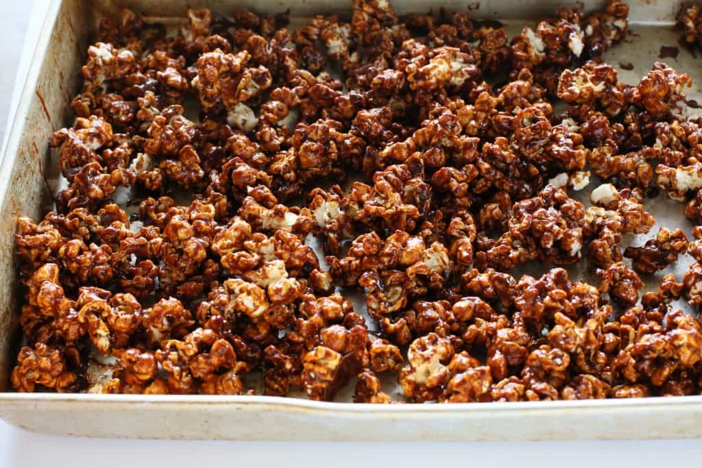 Gingerbread Caramel Popcorn - a crunchy popcorn with festive holiday flavors and drizzled with almond bark. A great neighbor gift for Christmas! the-girl-who-ate-everything.com