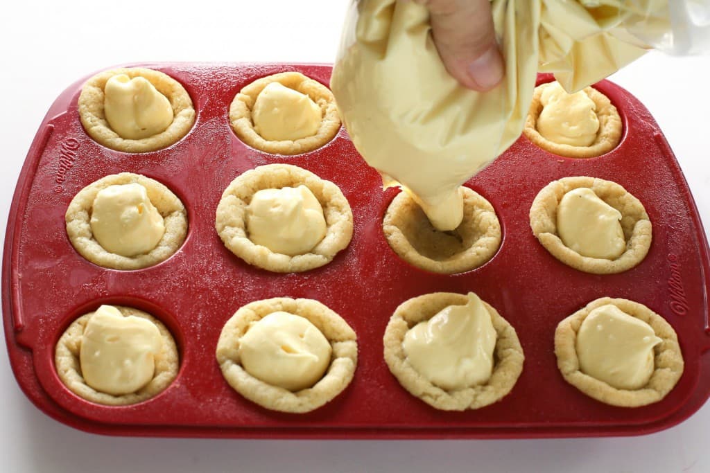 These Eggnog Cookie Cups are sugar cookie cups filled with a creamy eggnog filling. Super easy and festive for Christmas! the-girl-who-ate-everything.com