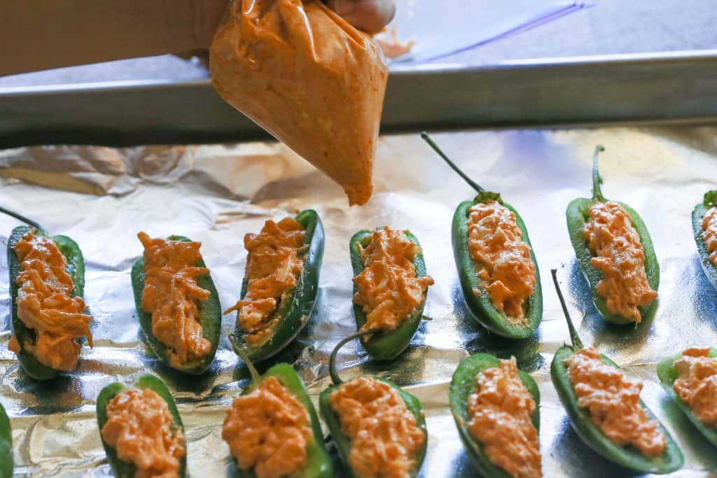Buffalo Chicken Jalapeno Poppers - buffalo chicken dip meets jalapenos! Game food right here. the-girl-who-ate-everything.com