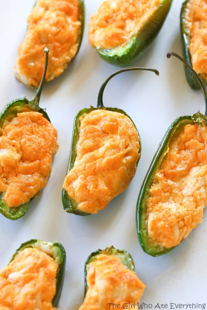 Buffalo Chicken Jalapeno Poppers - buffalo chicken dip meets jalapenos! Game food right here. the-girl-who-ate-everything.com