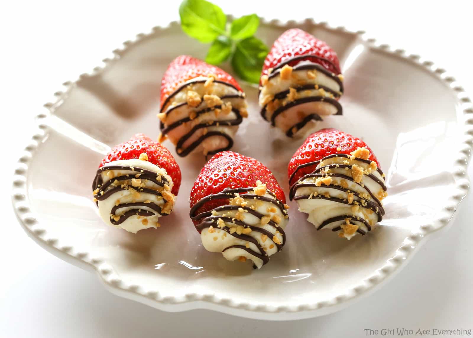 Mascarpone Stuffed Strawberrries. Sweet and silky mascarpone filled strawberries drizzled with chocolate and nuts. the-girl-who-ate-everything.com