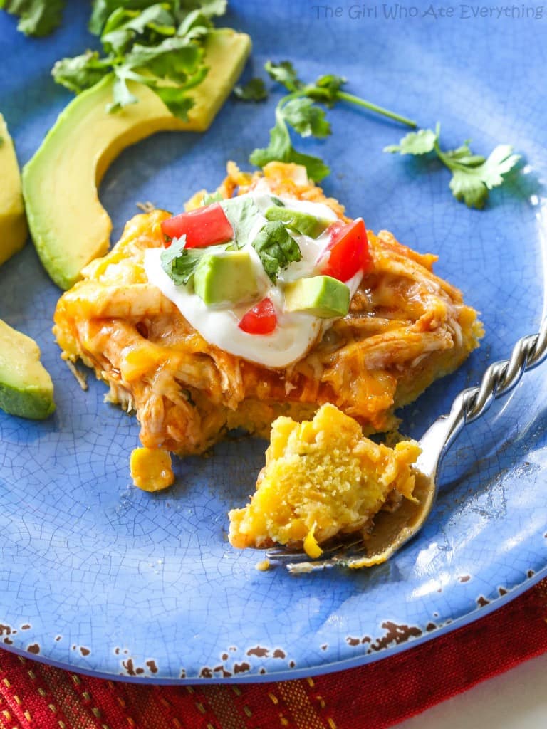 Chicken Tamale Casserole - a sweet cornbread crust topped with enchilada sauce and chicken. This is a crowd pleaser! the-girl-who-ate-everything.com