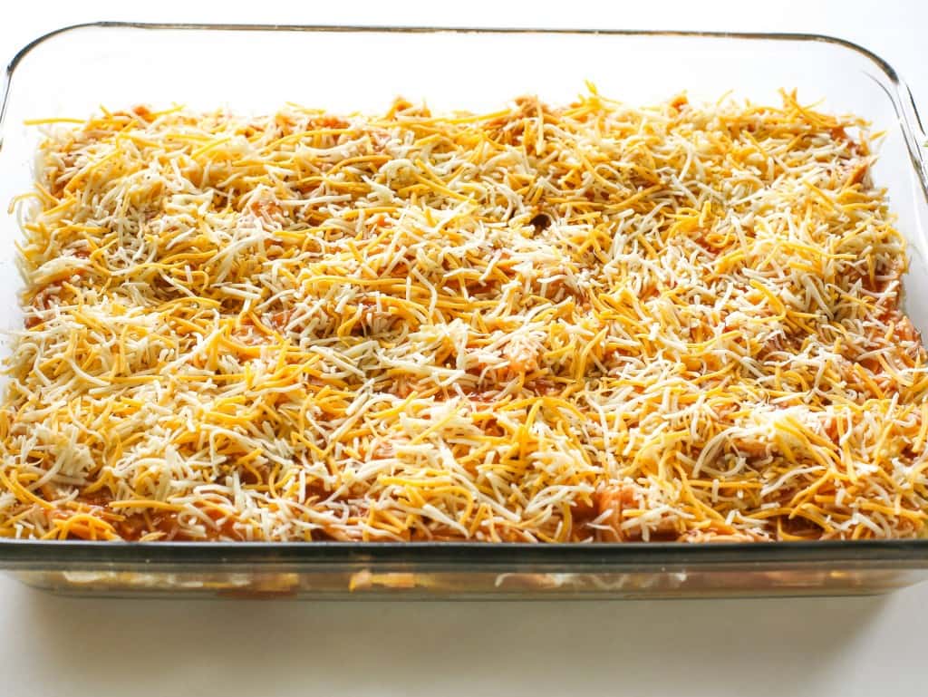 Chicken Tamale Casserole - a sweet cornbread crust topped with enchilada sauce and chicken. This is a crowd pleaser! the-girl-who-ate-everything.com