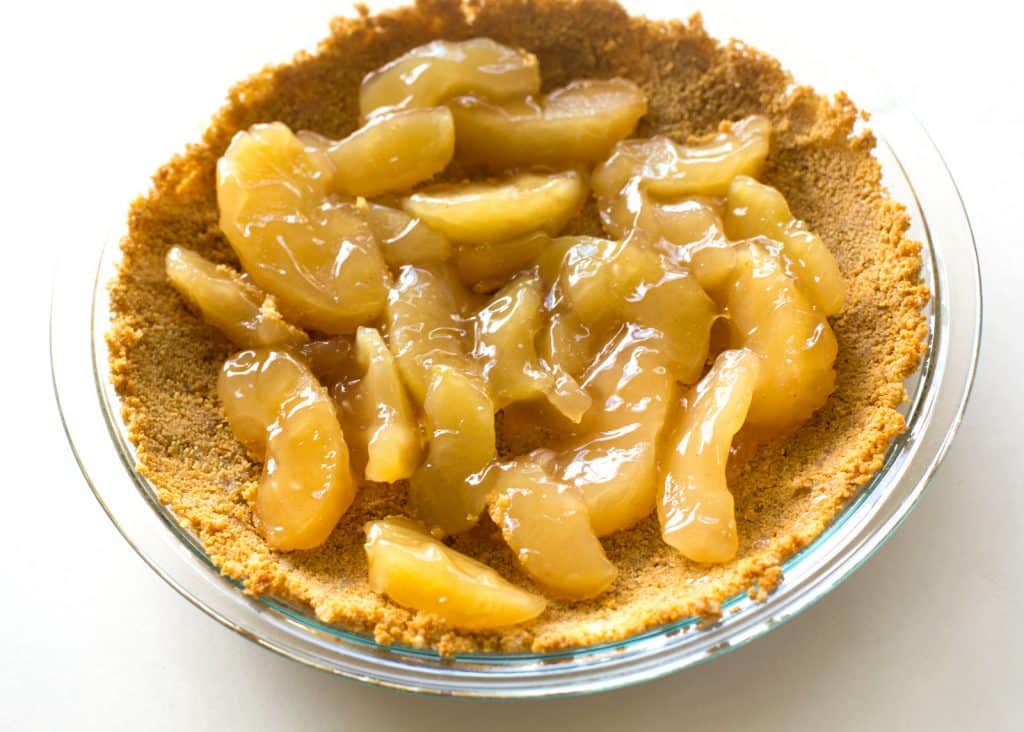 Caramel Apple Cheesecake - the easiest cheesecake with a graham cracker crust, apples, caramel, and nuts. the-girl-who-ate-everything.com