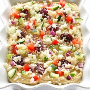 Greek Layered Hummus - If you want a quick and delicious snack, this Greek Layered Hummus is perfect! With the help of premade hummus, this snack comes together quickly and is full of flavor!