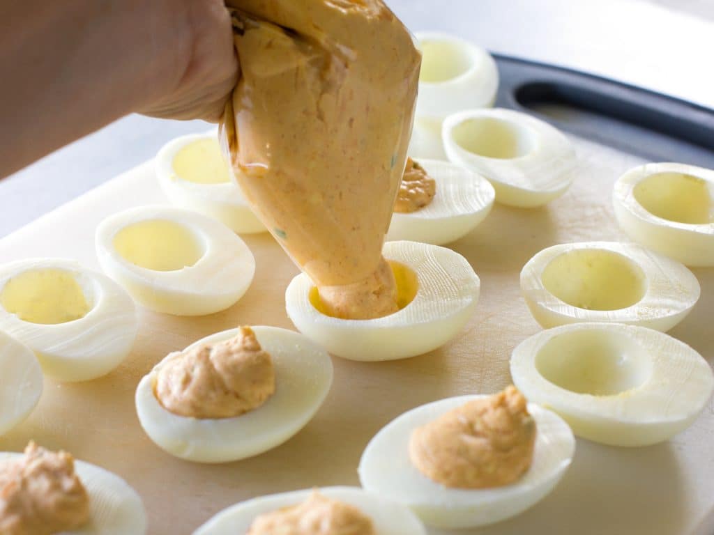 These Mexican Deviled Eggs are a spicy twist on your classic deviled eggs. the-girl-who-ate-everything.com