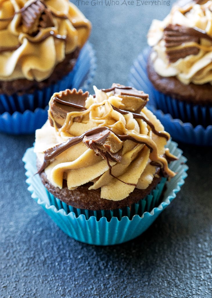 Reese's Peanut Butter Cupcakes - stuffed with Reese's Peanut Butter Cups and topped with a peanut butter frosting. the-girl-who-ate-everything.com