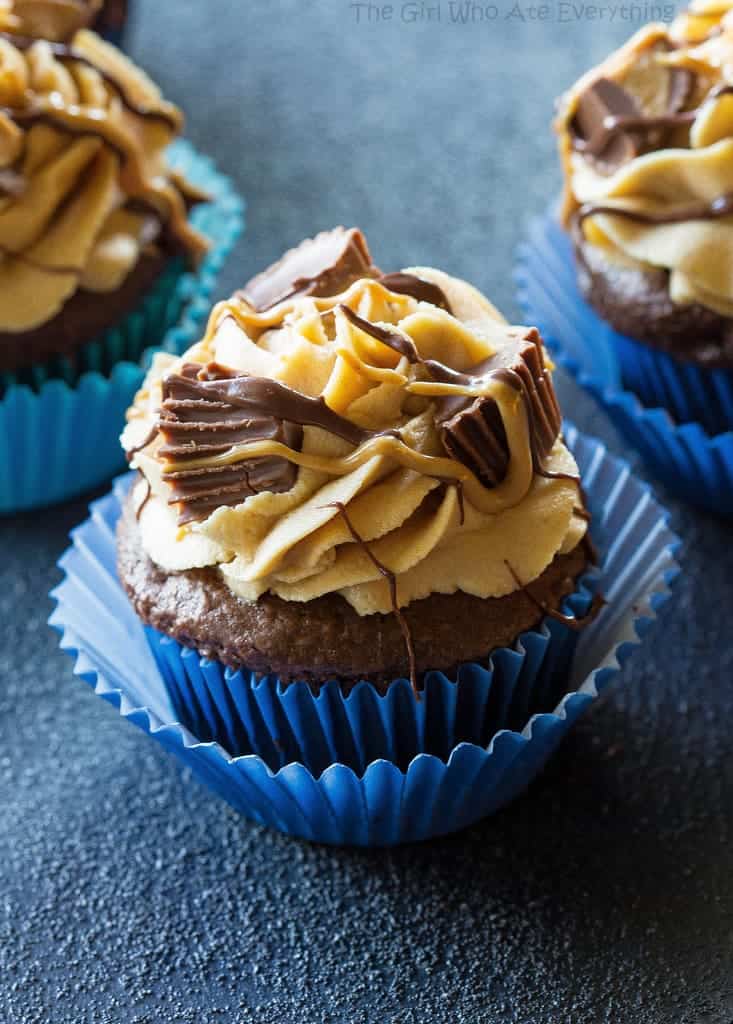 Reese's Peanut Butter Cupcakes - stuffed with Reese's Peanut Butter Cups and topped with a peanut butter frosting. the-girl-who-ate-everything.com