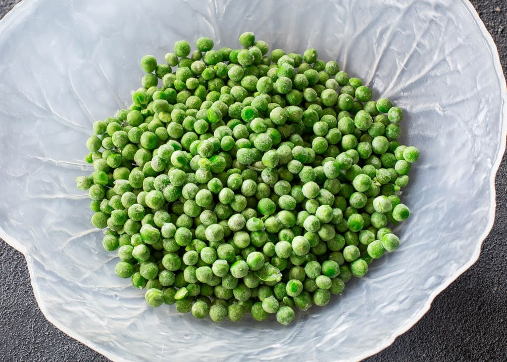 Crunchy Pea Salad - I know it sounds weird but trust me, it's good! Peas, nuts, bacon, celery...all for a refreshing salad. the-girl-who-ate-everything.com