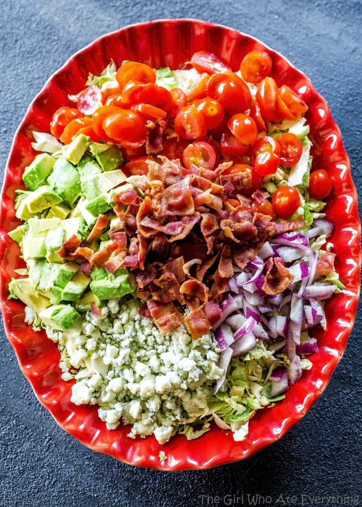 Brussels Sprouts Salad - shaved Brussels sprouts with bacon, onion, tomato, avocado, and gorgonzola cheese. the-girl-who-ate-everything.com