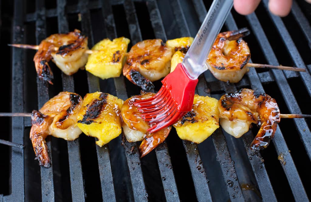 These Grilled Shrimp and Pineapple Skewers are served over coconut rice and have a sweet Teriyaki glaze. the-girl-who-ate-everything.com