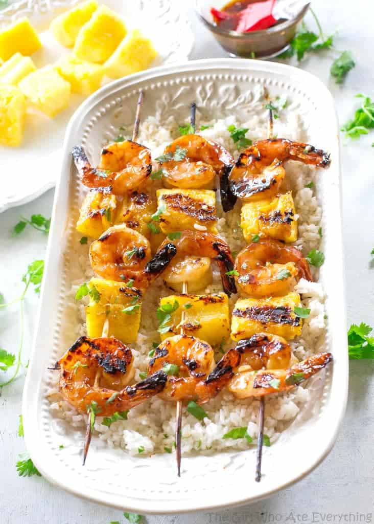 These Grilled Shrimp and Pineapple Skewers are served over coconut rice and have a sweet Teriyaki glaze. the-girl-who-ate-everything.com