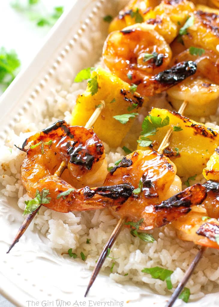 These Grilled Shrimp and Pineapple Skewers are served over coconut rice and have a sweet Teriyaki glaze. the-girl-who-ate-everything.com