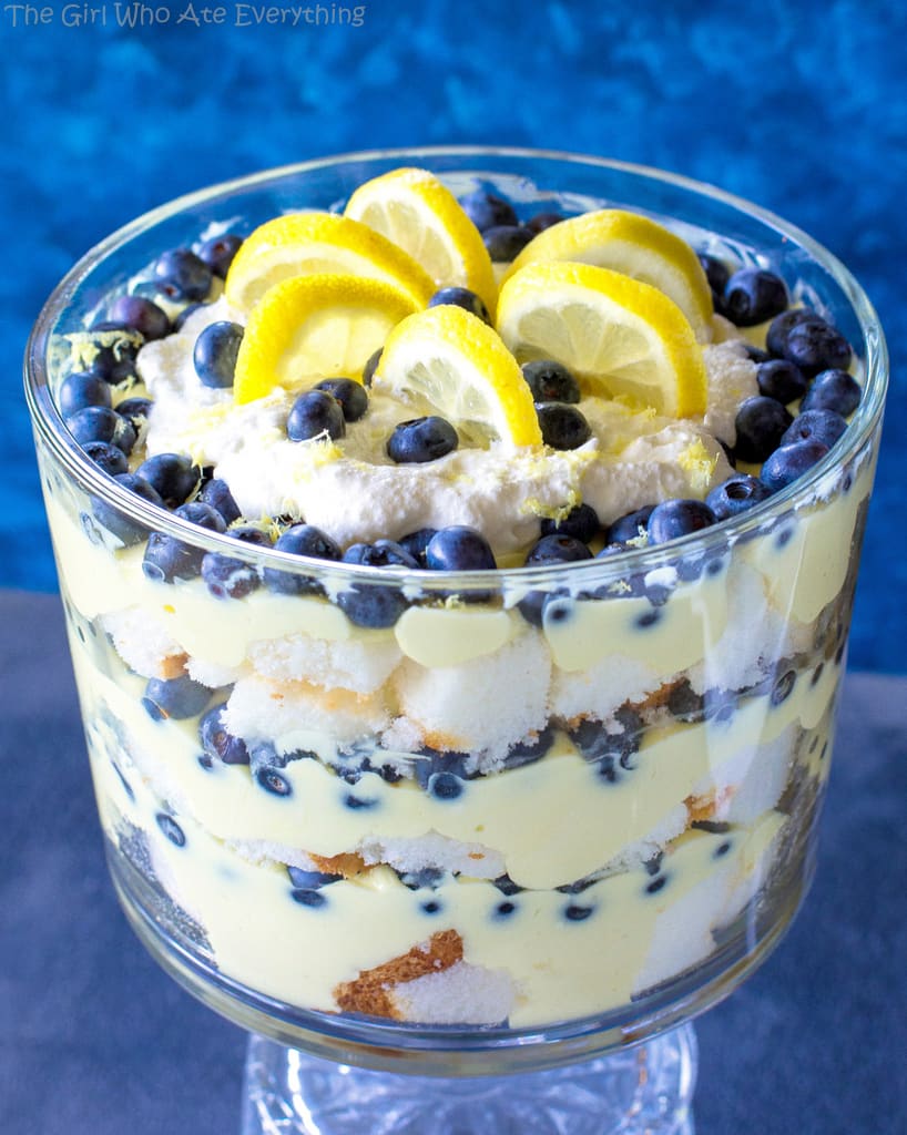 This Lemon Blueberry Trifle is layers of angel food cake, lemon pudding, and blueberries. A crowd pleasing dessert! the-girl-who-ate-everything.com