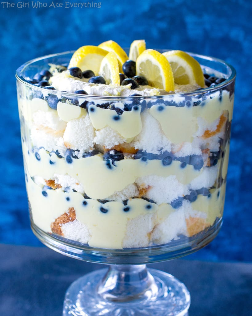 This Lemon Blueberry Trifle is layers of angel food cake, lemon pudding, and blueberries. A crowd pleasing dessert! the-girl-who-ate-everything.com