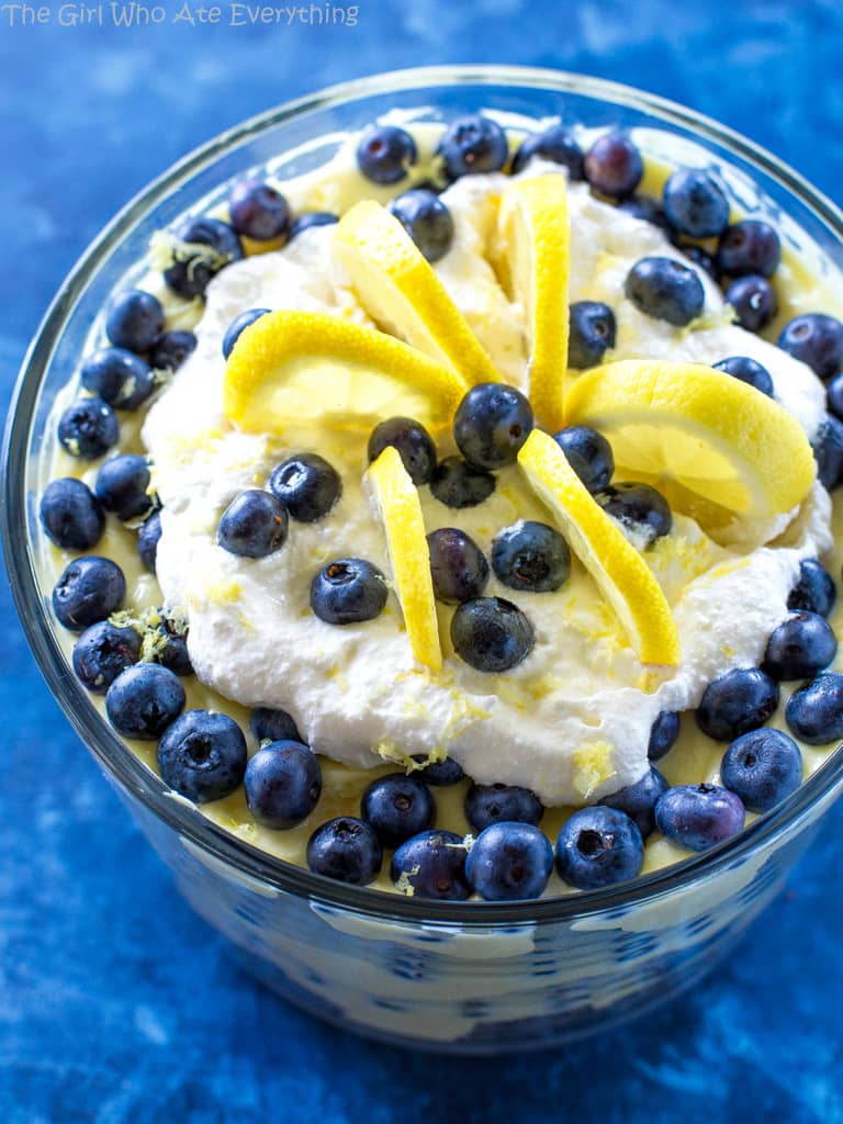 This Lemon Blueberry Trifle is layers of angel food cake, lemon pudding, and blueberries. A crowd pleasing dessert! the-girl-who-ate-everything.com